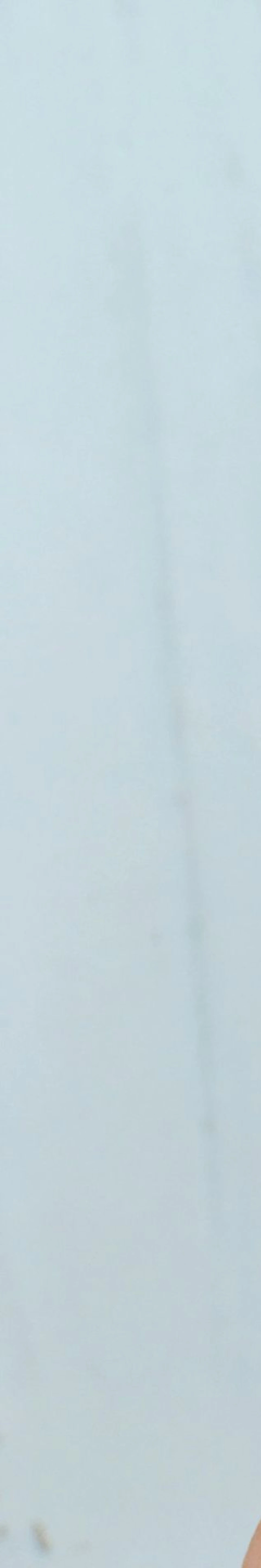 person holding ice cream cone with pink ice cream